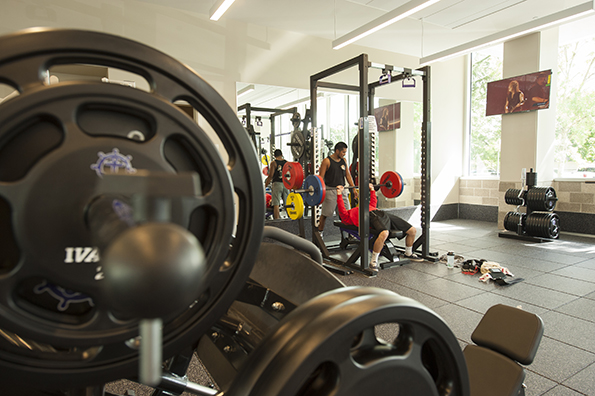 Student lifting weights in Beauchamp Recreation and Wellness Center