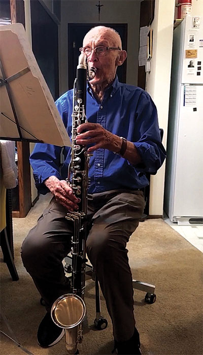 Fr. Claude Pomerleau playing the bass clarinet