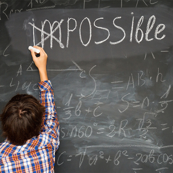child cross im from impossible above a math problem on chalkboard