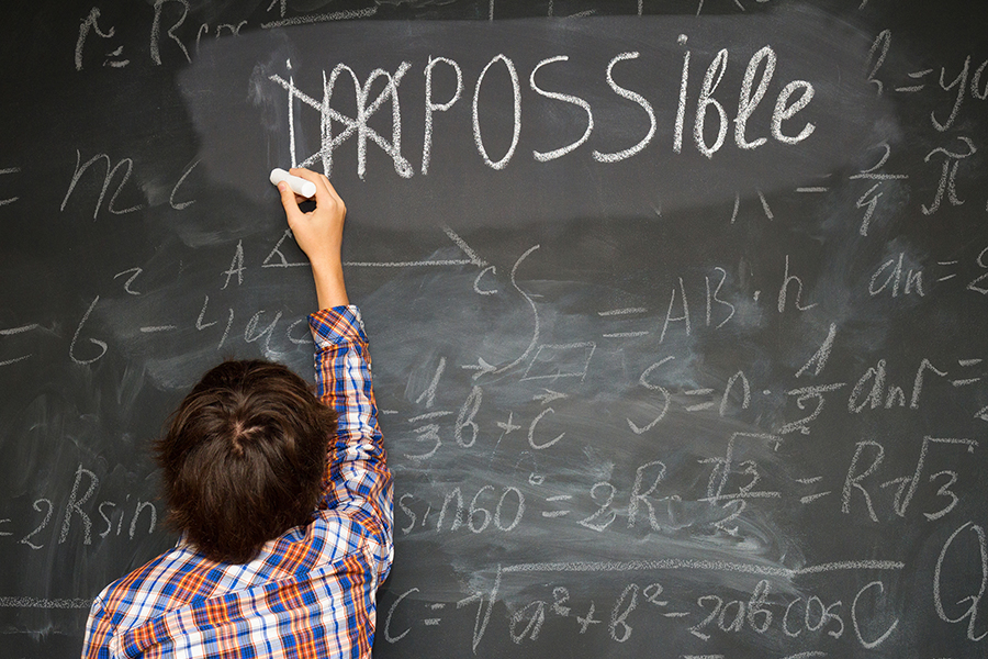 child crossing im from impossible over math problems on a blackboard