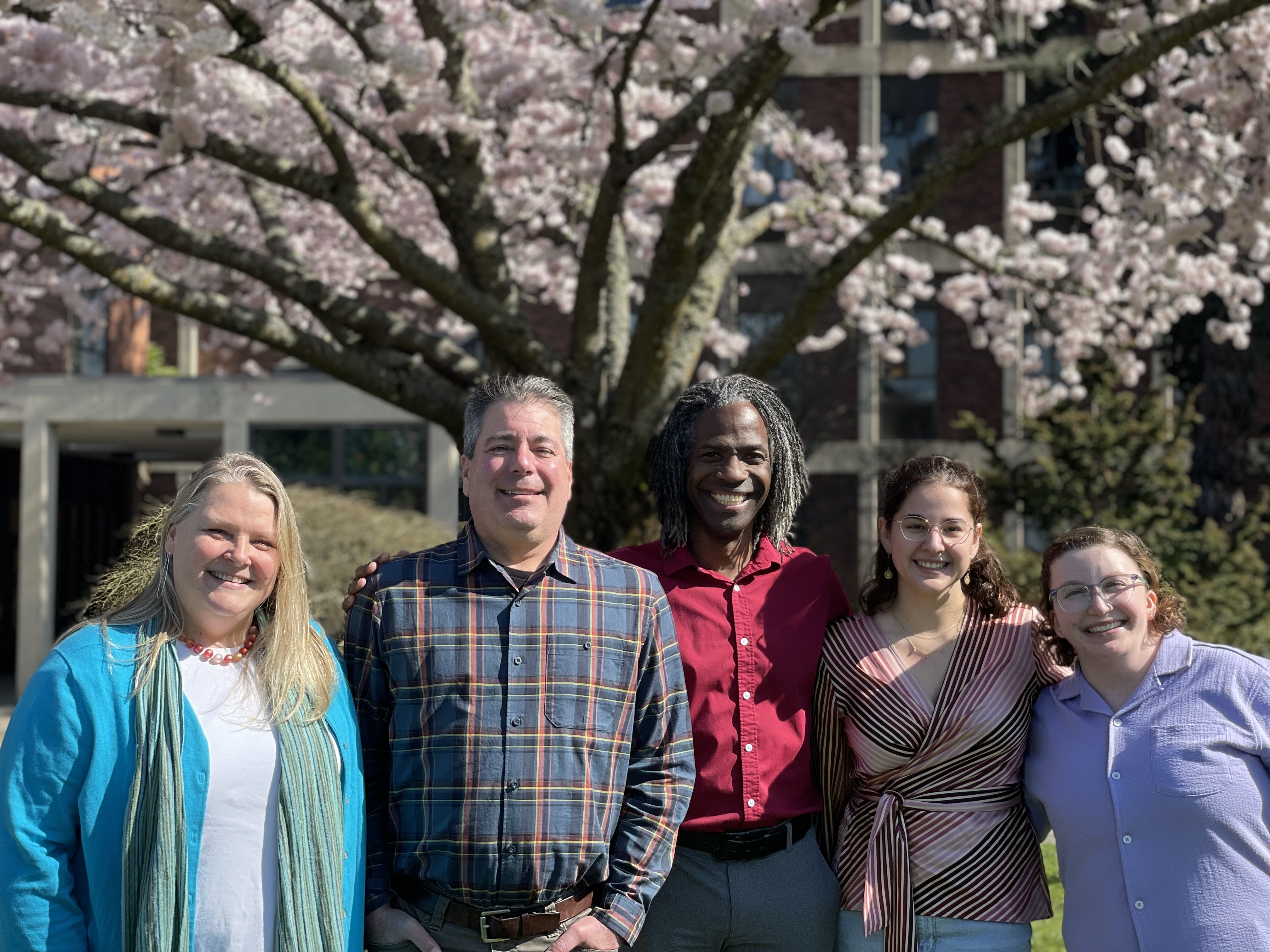 OIEDI staff in front of cherry blossoms