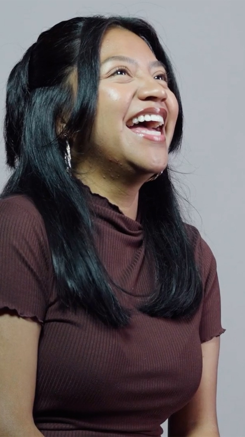 A portrait image of Andrea, a UP student, smiling broadly. 