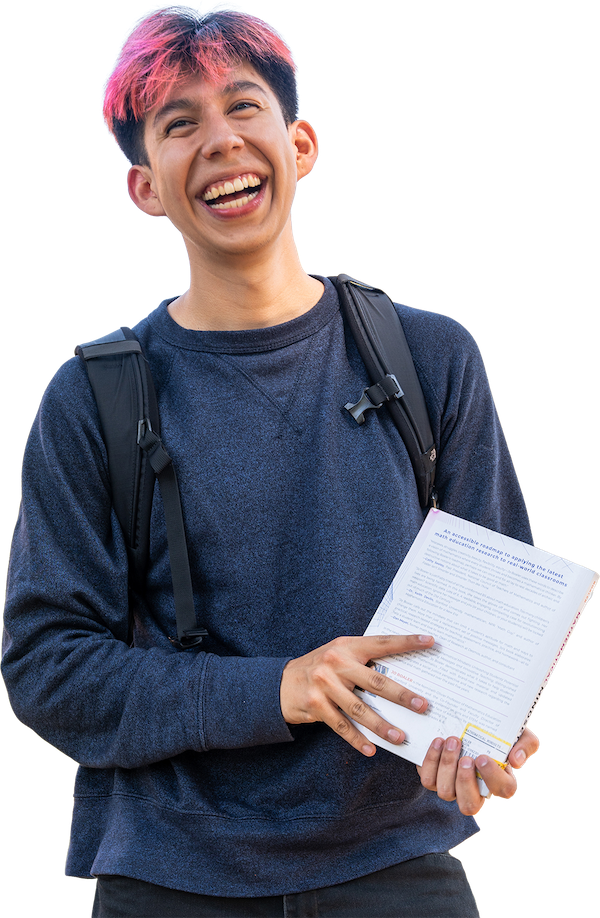 A smiling UP student holds a book while looking into the distance.
