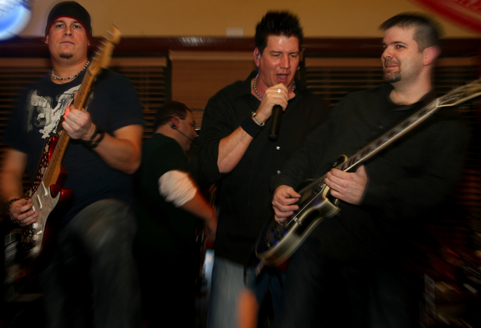 Rock band performing in a bar.