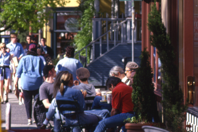 People sitting at tables at a sidewalk cafe on NW 223rd Ave.