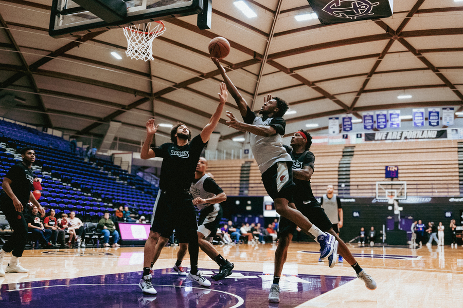A Rip City Remix basketball player attempts to dunk the ball while being guarded during a game in the Chiles Center.