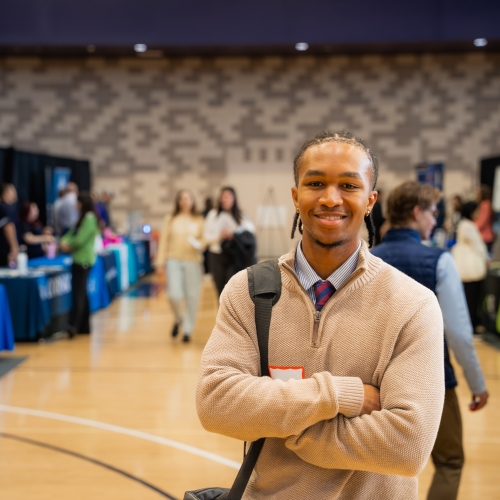 A student smiles confidently at the UP Career Fair event.
