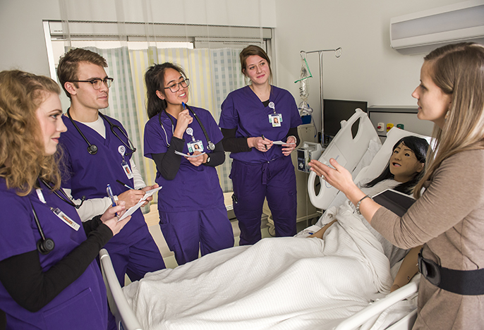 students and professor in Simulated Health Center