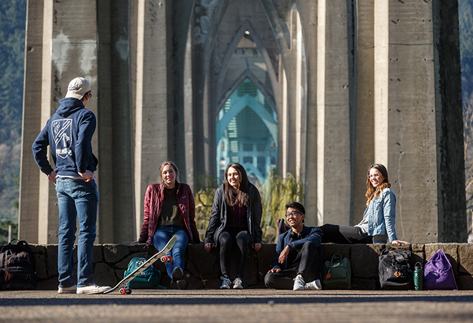 University of Portland students sitting under St Johns Bridge