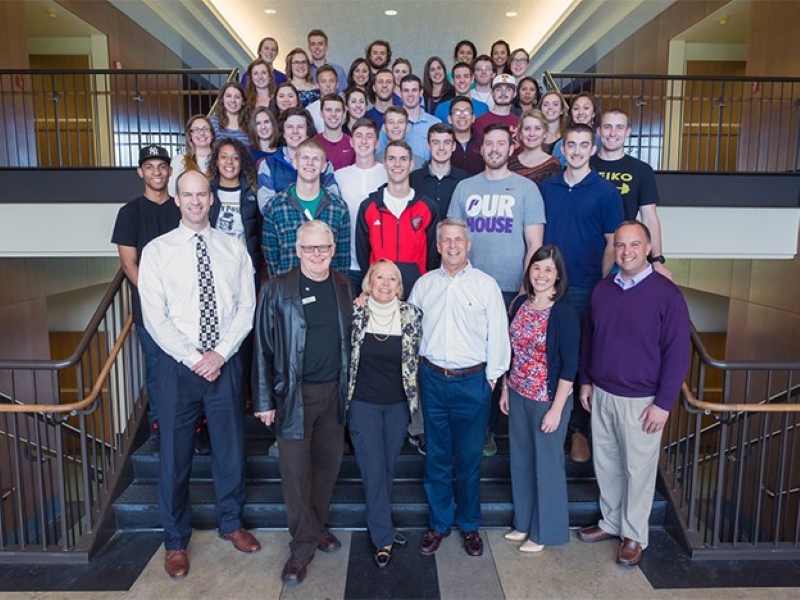 Group shot of Character Project students on the interior stairs of Franz Hall with professors and Jim Berchtold and Amy Dundon-Berchtold