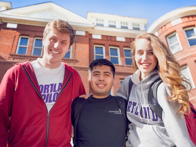 A diverse trio of two male and one female student