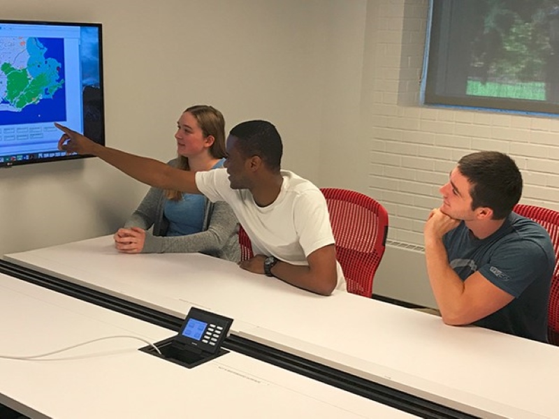 Students working around a conference table
