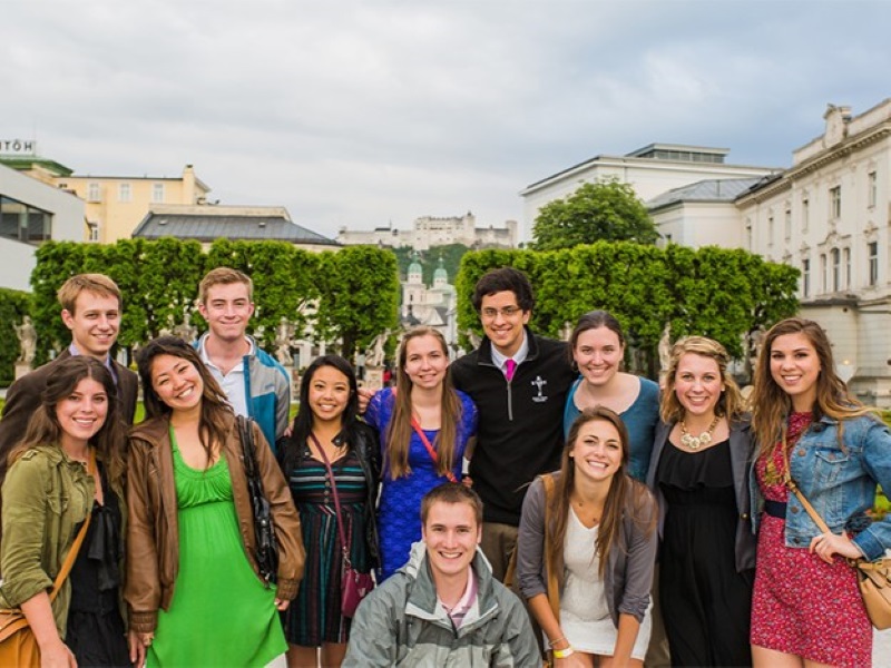 Group of male and female students with the Alps in the background