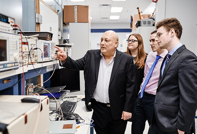 Students with engineer in lab