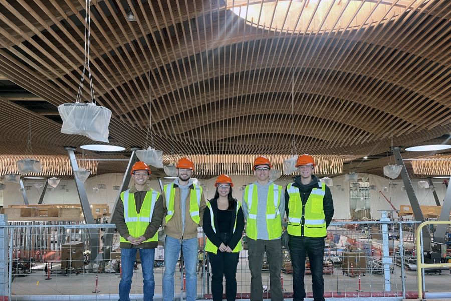 Civil engineering interns pose for a picture in the PDX airport construction project wearing their safety gear.