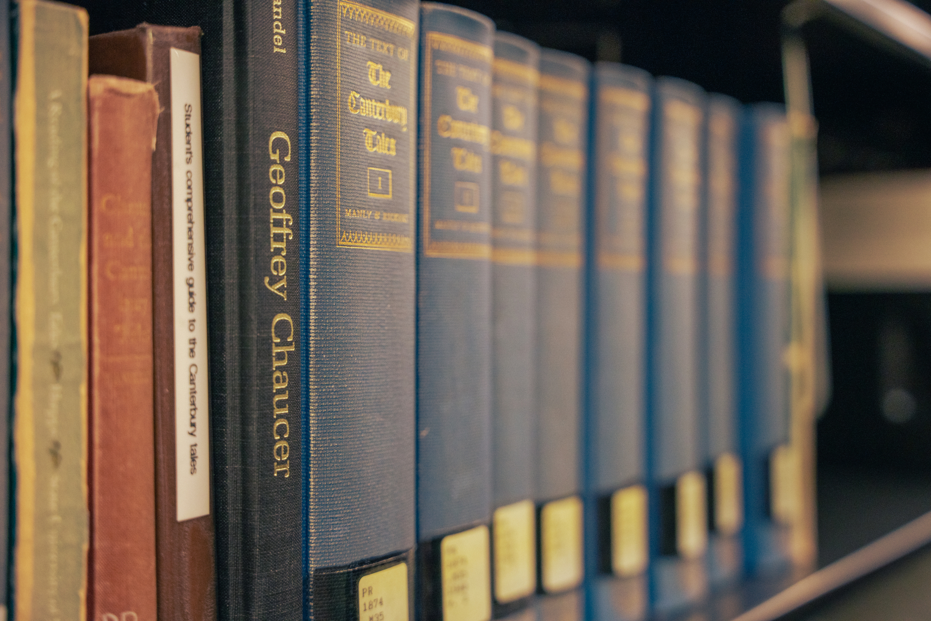 A shelf at Clark Library on the University of Portland campus that contains copies of Geoffrey Chaucer books such as the Canterbury Tales and other works.