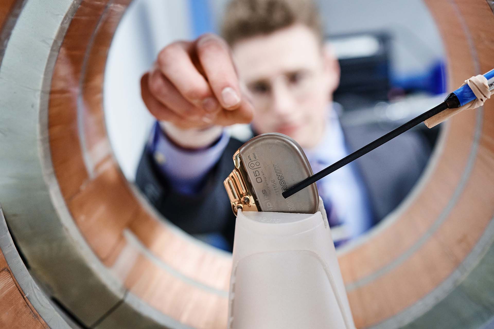 University of Portland engineering student reaching for a Biotronik medical device.