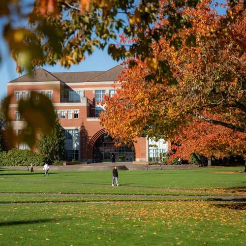 The academic quad of the University of Portland and Franz Hall framed by trees with brightly colored leaves in fall.