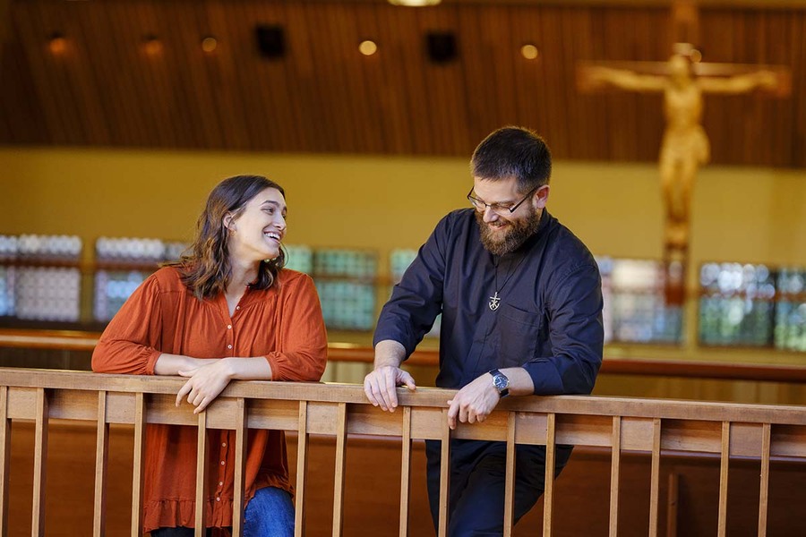 A University of Portland student and Fr Gallagher talk in the Chapel of Christ the Teacher