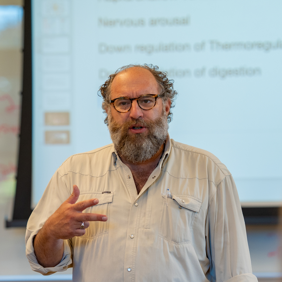 Close-up of a UP professor in a light beige button-up shirt with a pen in the chest pocket; bearded, head partially out of frame.