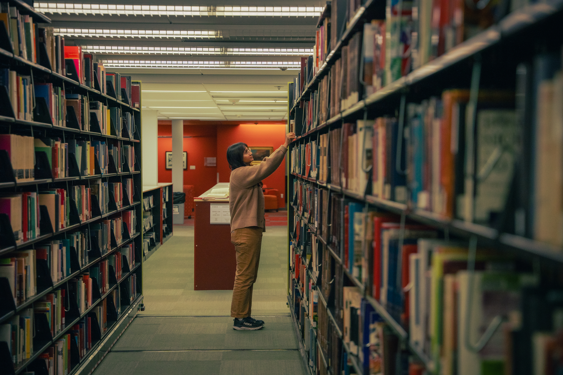 A student peruses books in Clark Library