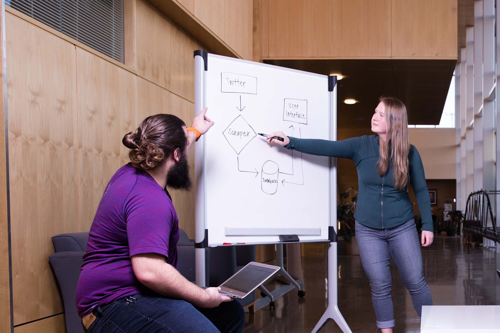 Two University of Portland computer engineering students discuss cyber data.