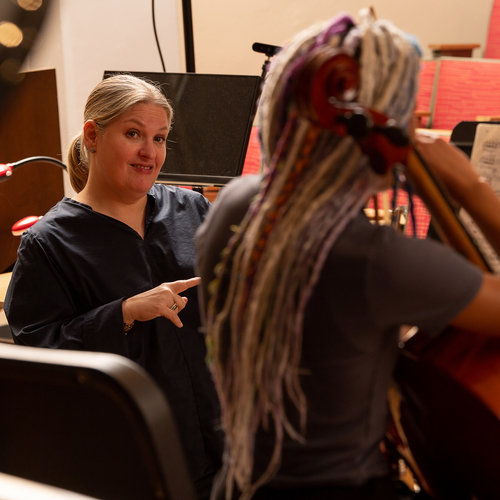 A candid image of a music student and their teacher during a performance class at the University of Portland.