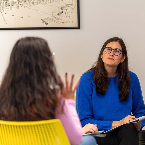 A University of Portland professor of education listens to a student speak during a small class on adolescent and children literature and libraries