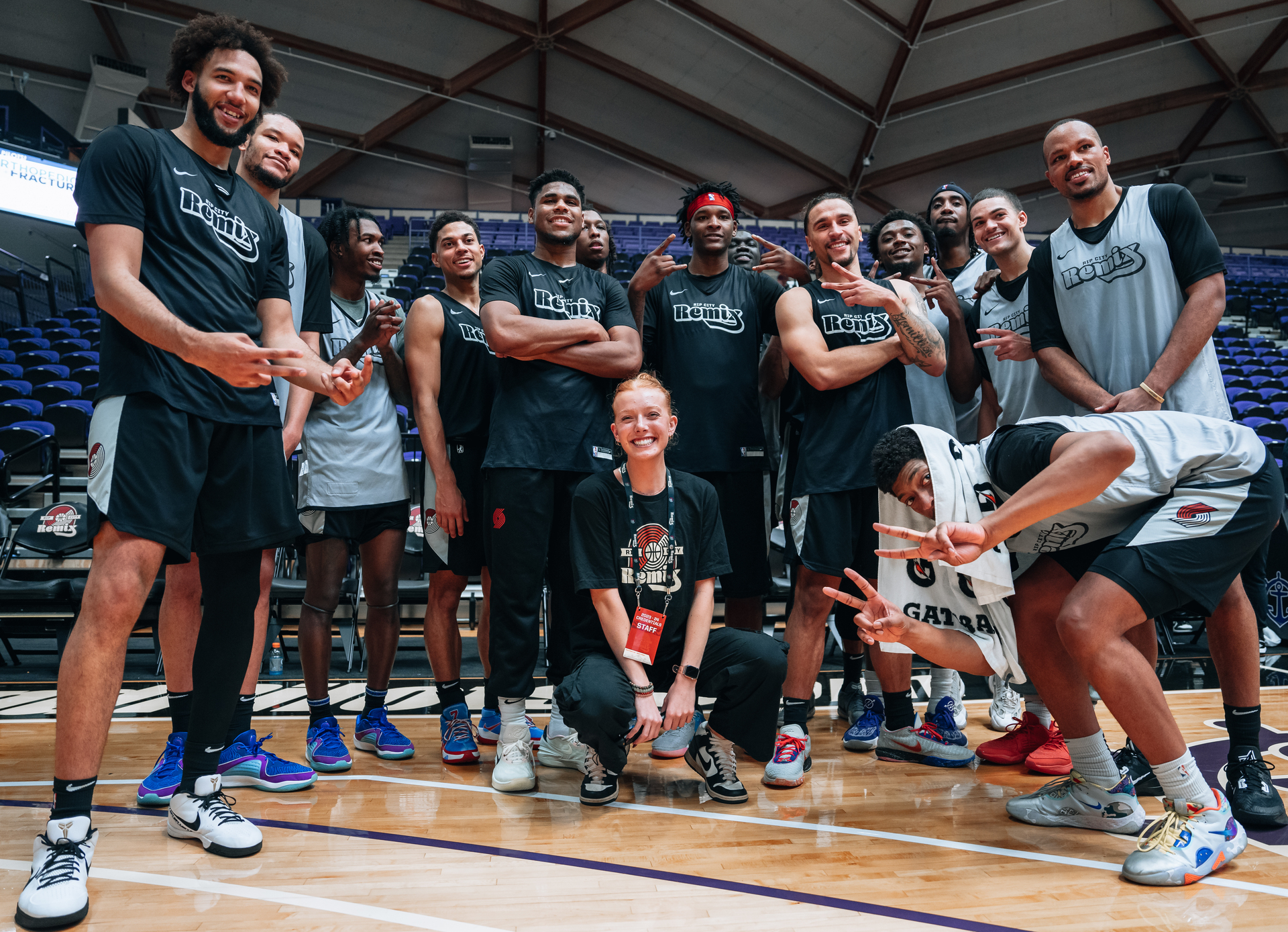Players from the Rip City Remix pose for a picture with a student intern on the court at the Chiles Center.
