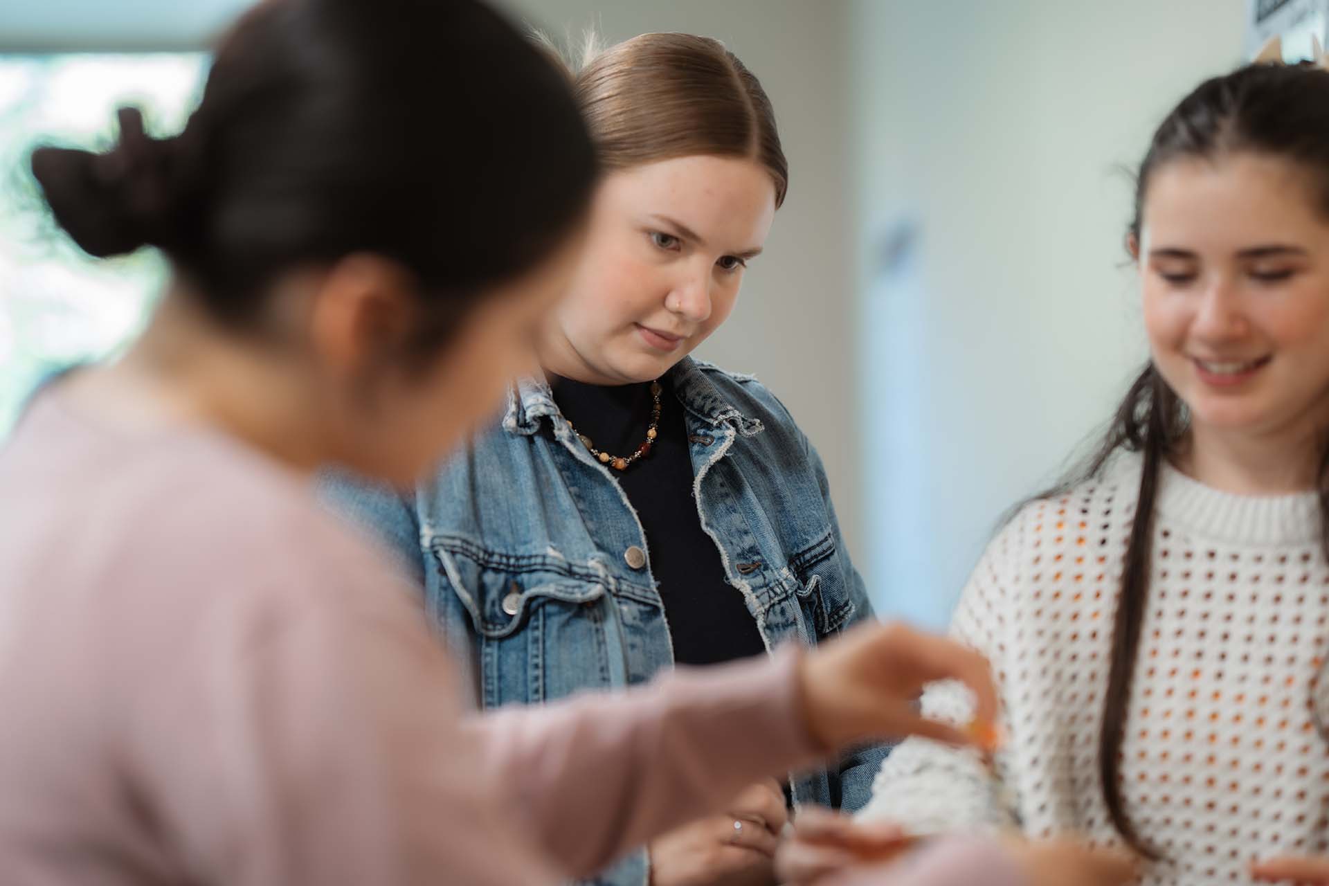 A University of Portland education student stands in a group during a class activity