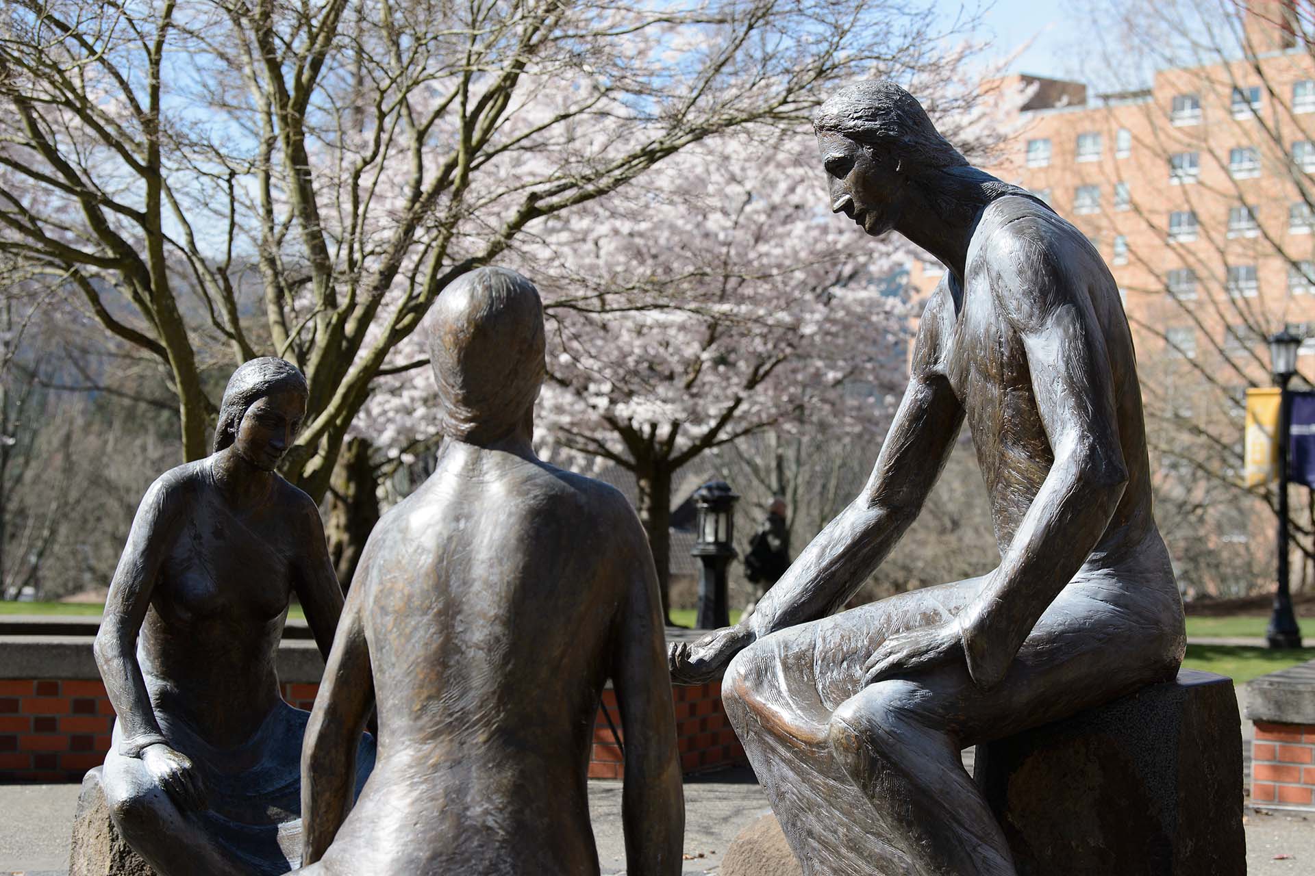 A portion of the Oddo Memorial outside of Franz Hall on the University of Portland campus with cherry blossoms budding in the background
