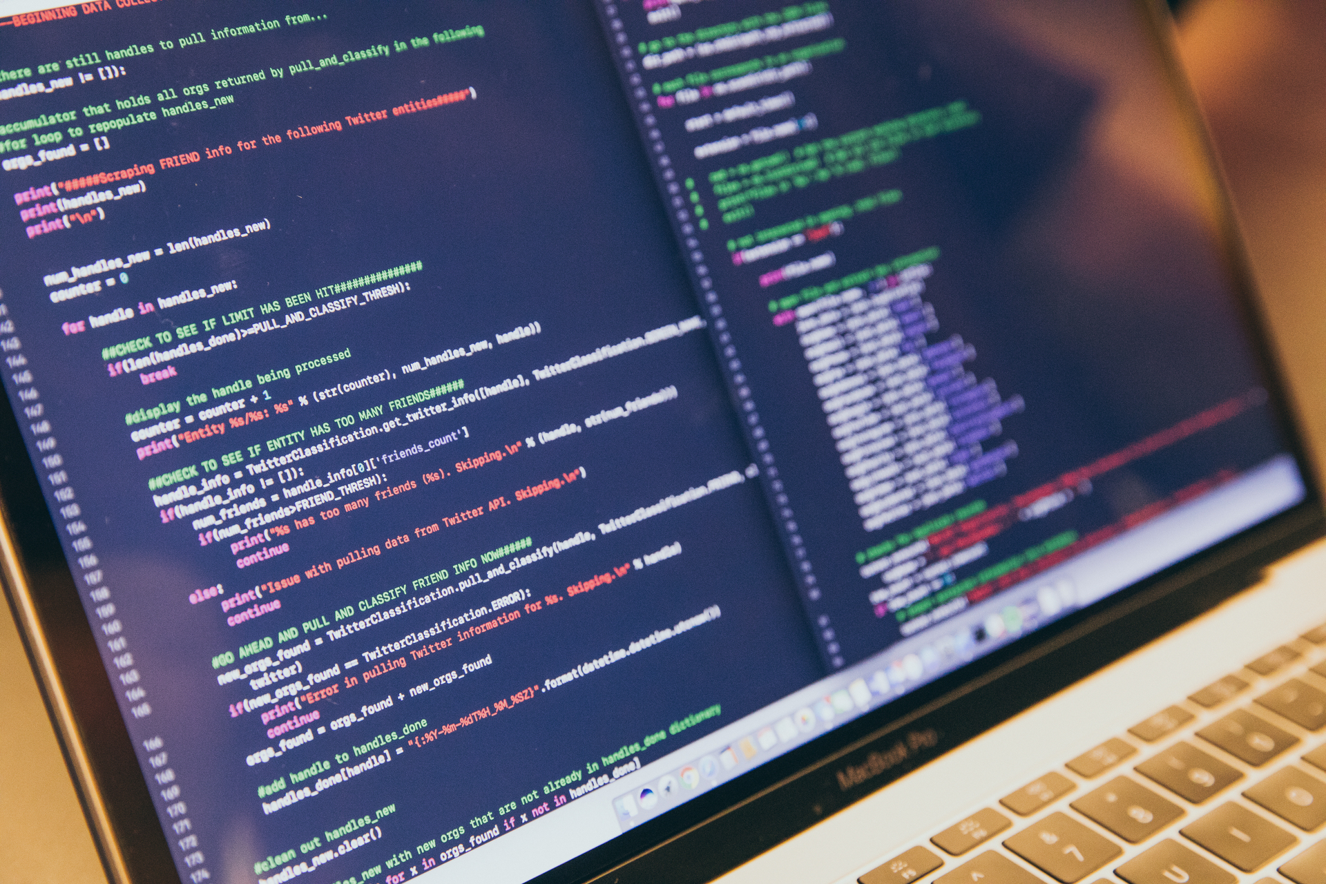 A computer monitor shows code for processing Twitter friend data, with syntax highlighting and lines marked in green and red for clarity.