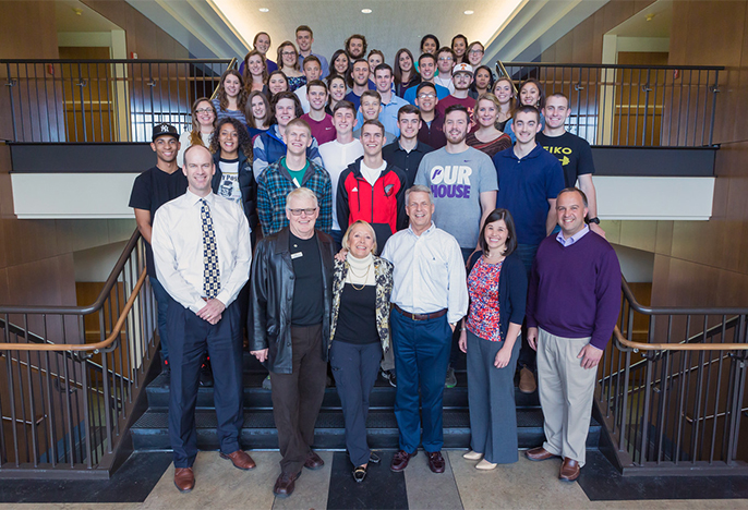 Group shot of Character Project students on the interior stairs of Franz Hall with professors and Jim Berchtold and Amy Dundon-Berchtold