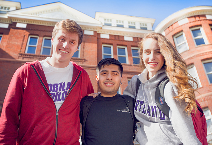 A diverse trio of two male and one female student