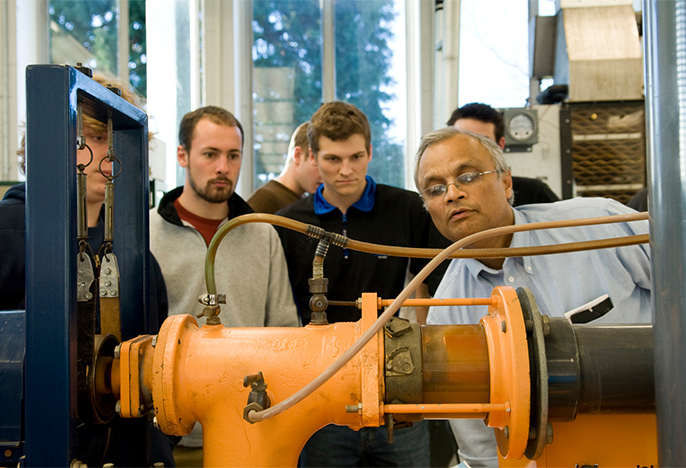 Engineering professors demonstrating equipment