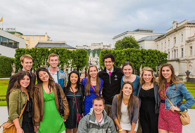 Group of male and female students with the Alps in the background