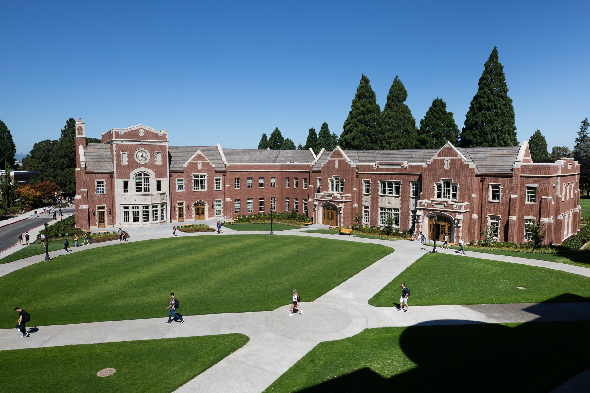 Students walking outside near Dundon-Berchtold Hall