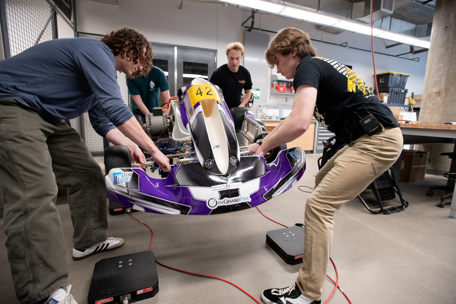 Engineering students working on grand prix car