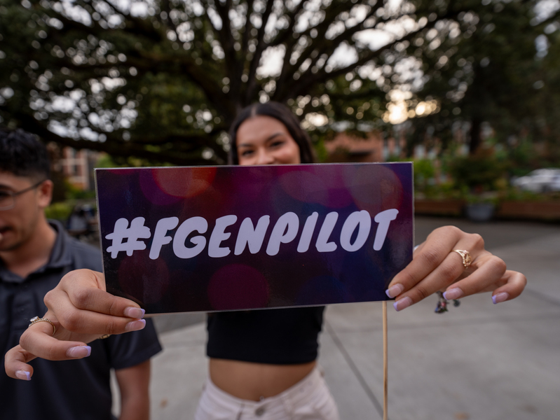 Student holding a sign that says FGEN Pilot