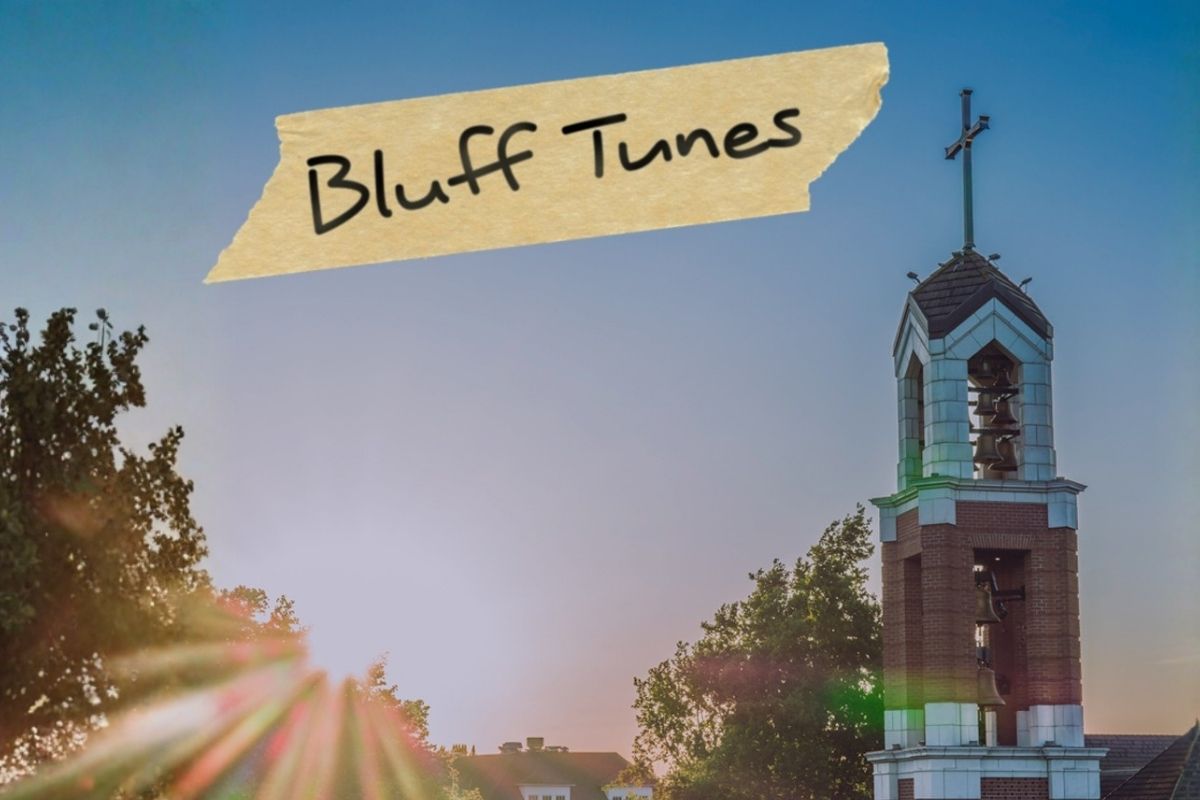 A filtered image of the UP Bell tower with a piece of masking tape in the corner that says Bluff Tunes