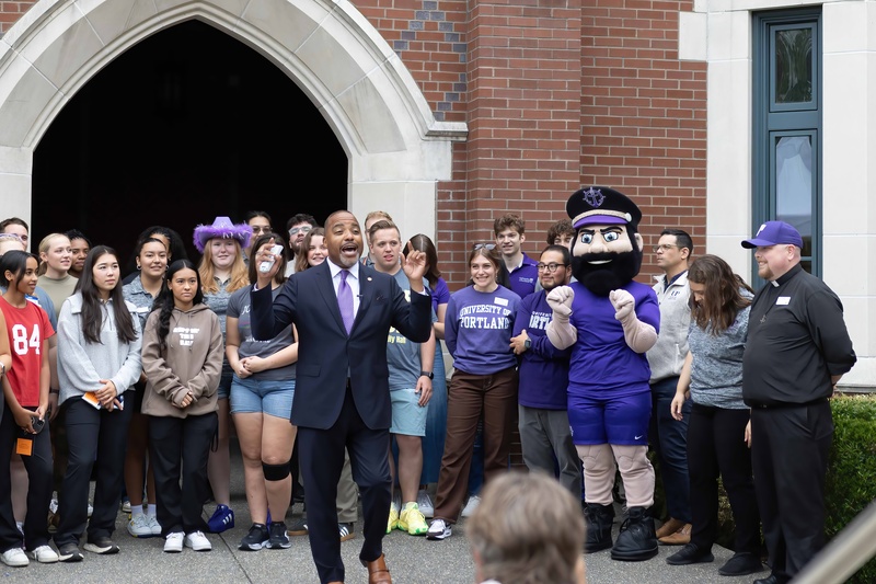 A group of staff and students welcome new students