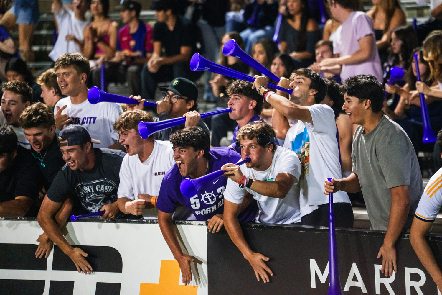 Group of students cheering at a soccer game