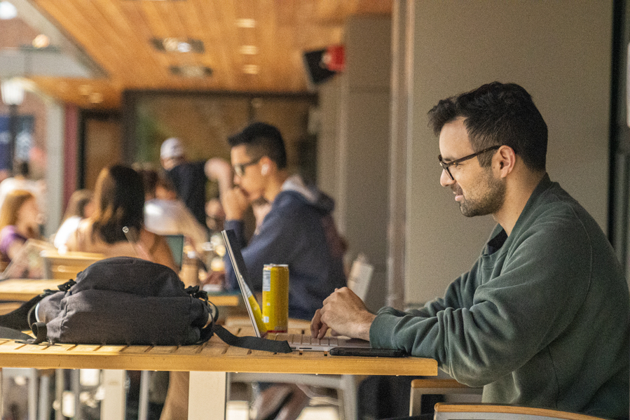 Student studying outside the Pilot House