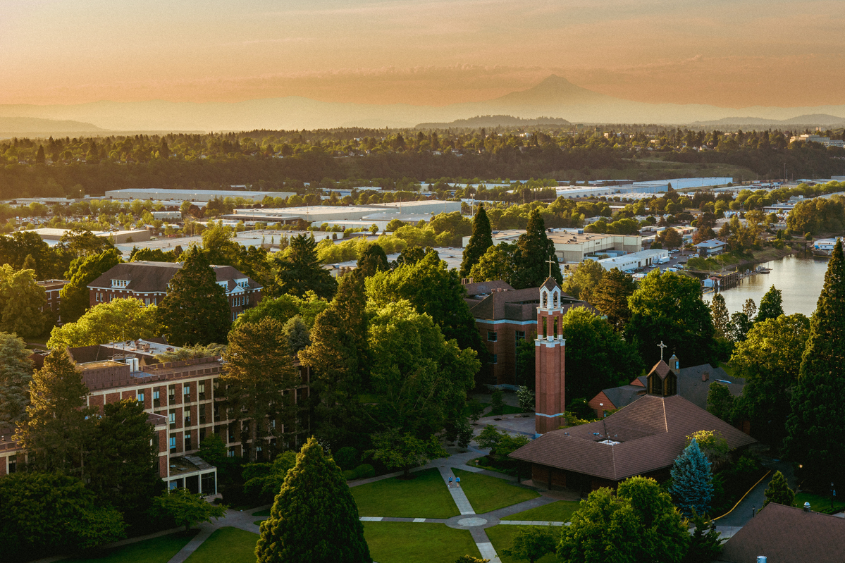 An aerial view of University of Portland's campus and Mount Hood at sunset.
