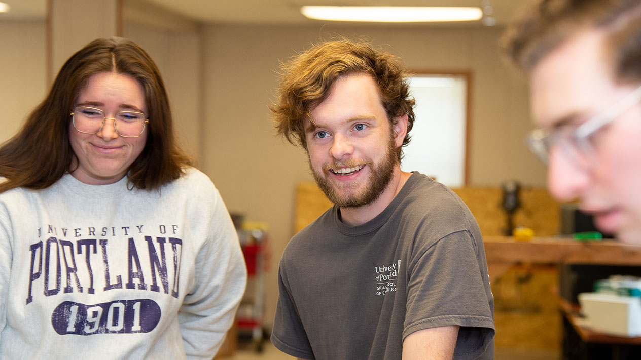 A graduate student enjoys working with a group on a project