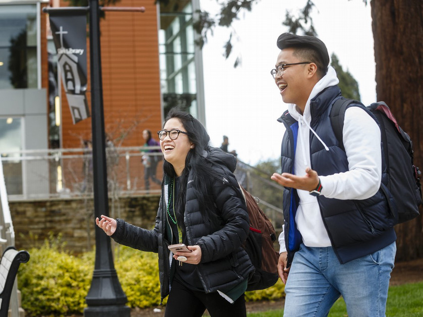 students walking by library