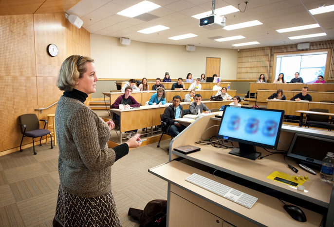 Students attend a lecture in a classroom.