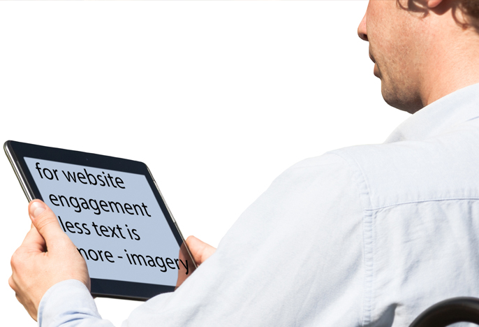 Student holds tablet displaying large format text.