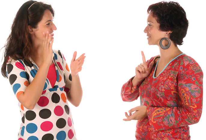 Women speak using sign language.