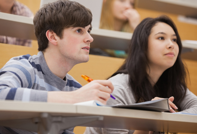 Students in classroom taking notes.